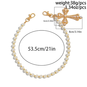 Detail showing 53.5cm pearl waist chain with a large 8cm gold hollow cross pendant