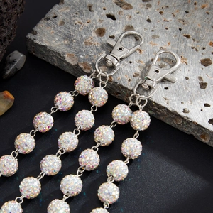 Detail of hip hop trouser chain featuring colorful rhinestone encrusted spheres and metal clasp