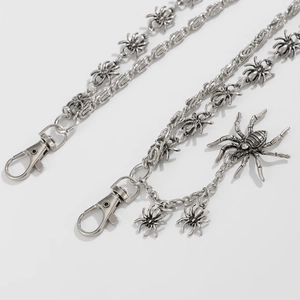 Detail of vintage silver metal spider pants chain with intricate links and lobster clasp