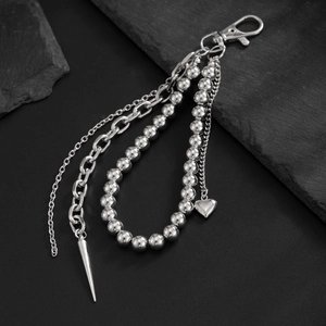 Detail of silver multi-layer keychain with bead chain and punk style cone pendant