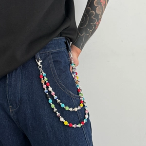 Detail view of double-layer hip hop trouser chain with colorful rhinestones on blue jeans