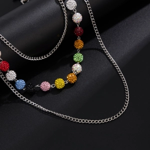 Detail view of colorful diamond spheres on a silver Cuban link punk style waist chain
