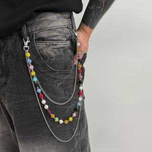 Close-up of triple-layered metal pants chain featuring colorful rhinestones on jeans