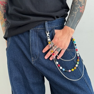 Detail of multi-layered punk trousers chain with colorful glitter beads and lobster clasp
