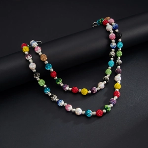 Macro detail of colorful disco ball beads with sparkling rhinestones on hip-hop waist chain