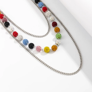 Macro shot of silver chains featuring colorful pavé rhinestone balls for hip-hop style