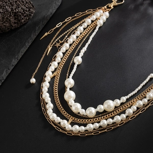 Close-up of pearl tassels and gold chains with star pendants on hip hop pants link