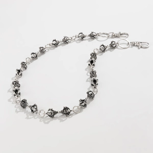 Detail of punk style silver metal pants chain with crown links and lobster clasp