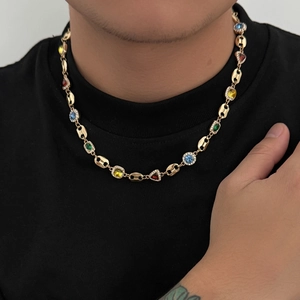 Detail of gold coffee bean link necklace with colorful gemstones and white zircon halo