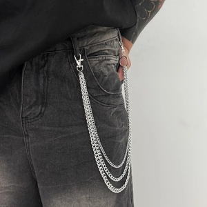 Close-up of triple layered silver metal jean chain with lobster clasps and industrial style