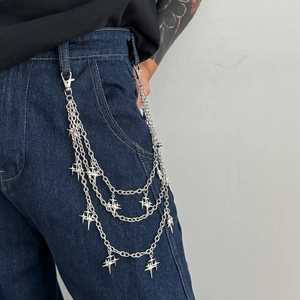 Close-up of triple-layered silver star pants chain on blue denim for street style