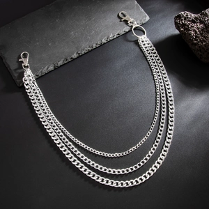 Three-layer silver curb chain trousers belt link with lobster clasps on dark stone background