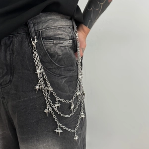 Close-up of multilayer silver metal pants chain with punk star pendants for hip-hop style