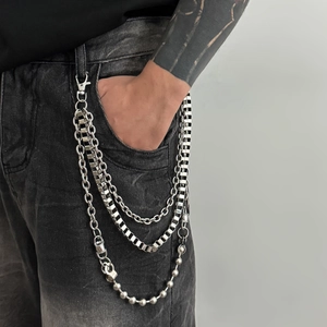 Detailed view of triple-layered silver metal pants chains with ball and link styles