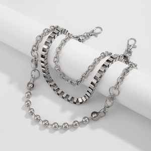 Close-up of triple-layered silver metal pants chains with ball and box link textures
