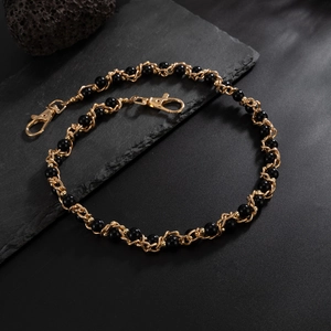 Detail of woven hip-hop pants chain with gold metal links and polished black beads
