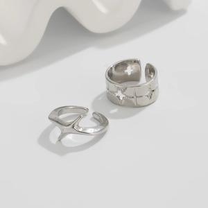 Detailed view of silver star hollow ring and irregular thorn band set for men
