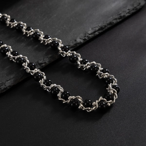 Detail of hip-hop pearl waist chain featuring black beads and silver metal links