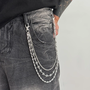 Three-layer silver metal pants chain with 3D star pendants on gray denim jeans