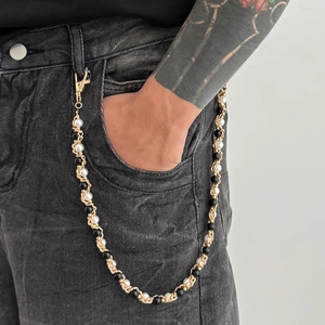 Hip hop style gold metal chain waist link with black and white pearls on black jeans