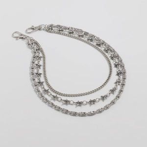 Close-up of three-layer silver metal pants chain with hollow star pendants and lobster clasps
