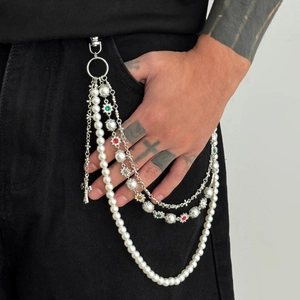 Detail of multi-layer hip hop trousers chain with white pearls and cross pendant