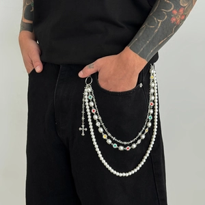 Detail of hip hop layered trousers chain with cross pendant and colorful flower charms