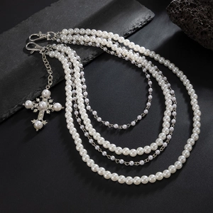 Multilayer pearl and metal chain necklace with a sparkling rhinestone cross pendant