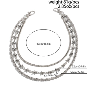 Detailed view of silver triple-layered pant chain with star charms and lobster clasps