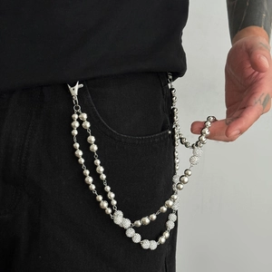 Detail of silver double layer pants chain featuring polished beads and pavé rhinestone balls