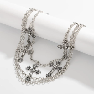 Detail of multi-layer hip hop pants chain featuring vintage silver cross pendants