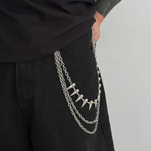 Detailed macro of a triple-layered silver metal hip hop waist chain with punk spikes