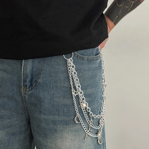 Detail shot of triple-layer silver hip-hop pants chain with sun moon and star charms