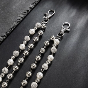 Close-up of pearl and rhinestone ball trouser chain with silver metal lobster clasps