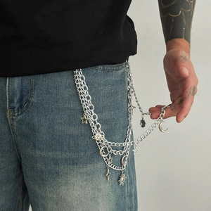 Hip hop multilayer silver metal waist chain with sun, moon, and star pendants on jeans