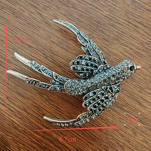 Detail view of the vintage silver swallow brooch showing dimensions 5.3cm by 6.7cm
