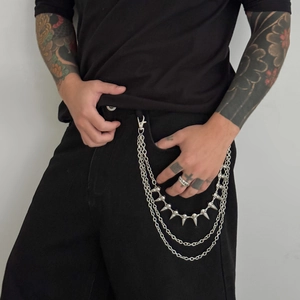 Close-up of triple-layered silver metal pants chain featuring conical punk style spikes