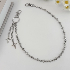 Close-up of punk silver metal pants chain with hollow star pendants on white background