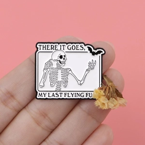 Funny enamel skeleton and bat pin badge with humor text on pink background