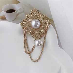 Baroque vintage gold pearl brooch with hollow floral design and elegant hanging chains