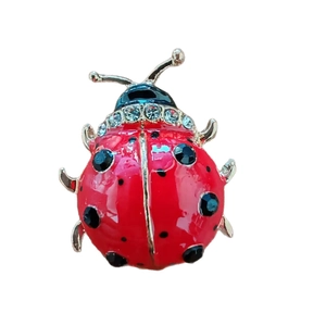 Broche coccinelle dorée avec ailes en émail rouge et cristaux de zircone scintillants