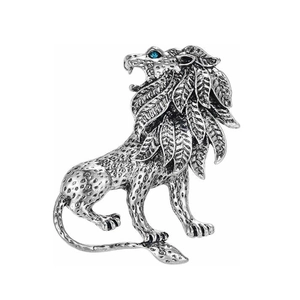 Vintage silver lion brooch with blue gemstone eye and intricate feather-like mane details
