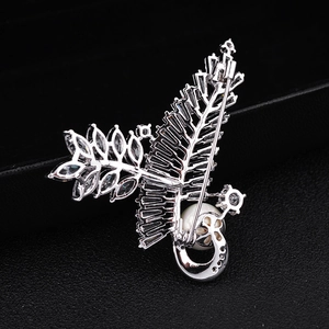 Macro shot of silver zircon leaf brooch showing the safety pin back and hollow metalwork