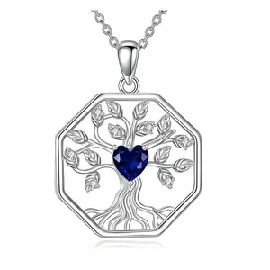 Detailed close-up of tree of life pendant with heart-shaped blue gemstone in silver