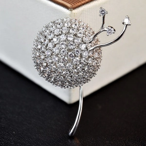 Detailed close-up of a silver dandelion brooch featuring sparkling micro-pave cubic zirconia
