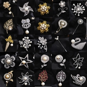 Detailed collection of 25 elegant brooches featuring pearls, crystals, and gold-tone designs