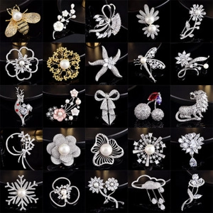 Matrix collection of 25 crystal pearl brooches in animal and floral shapes on black back