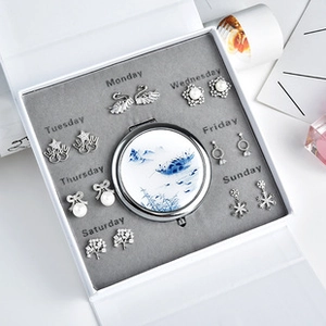 Luxury weekly earring gift set with seven pairs of silver studs and makeup mirror