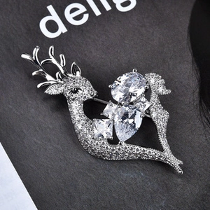 Detailed close-up of a silver reindeer brooch featuring zircon and faceted gemstones