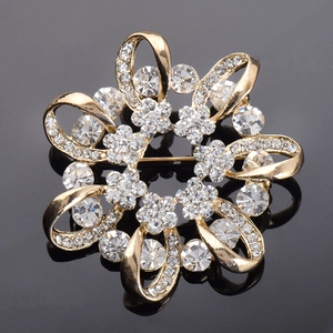 Broche couronne de fleurs dorée élégante avec cristaux brillants sur fond noir poli